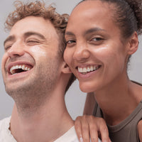 Boy and girl applying skincare 